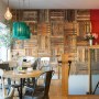 The Oxford Wine Cafe | Cafe area, showing back wall clad in reclaimed wooden palettes | Interior Designers