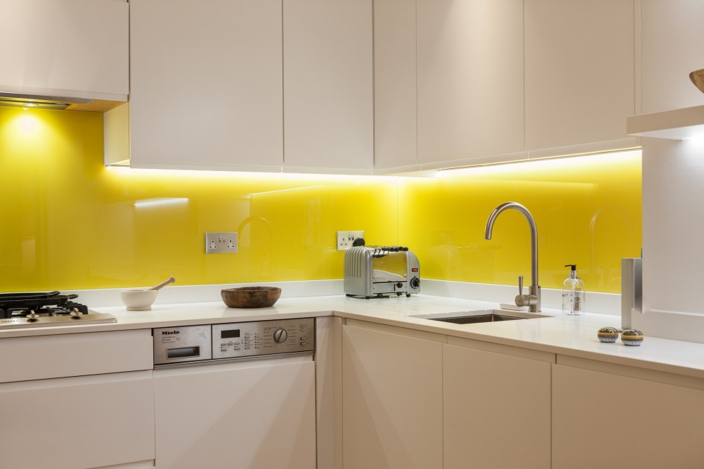 Kensington Basement | White kitchen with yellow splashbacks | Interior Designers