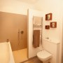 Bathroom with a tropical twist | wood box shelves | Interior Designers