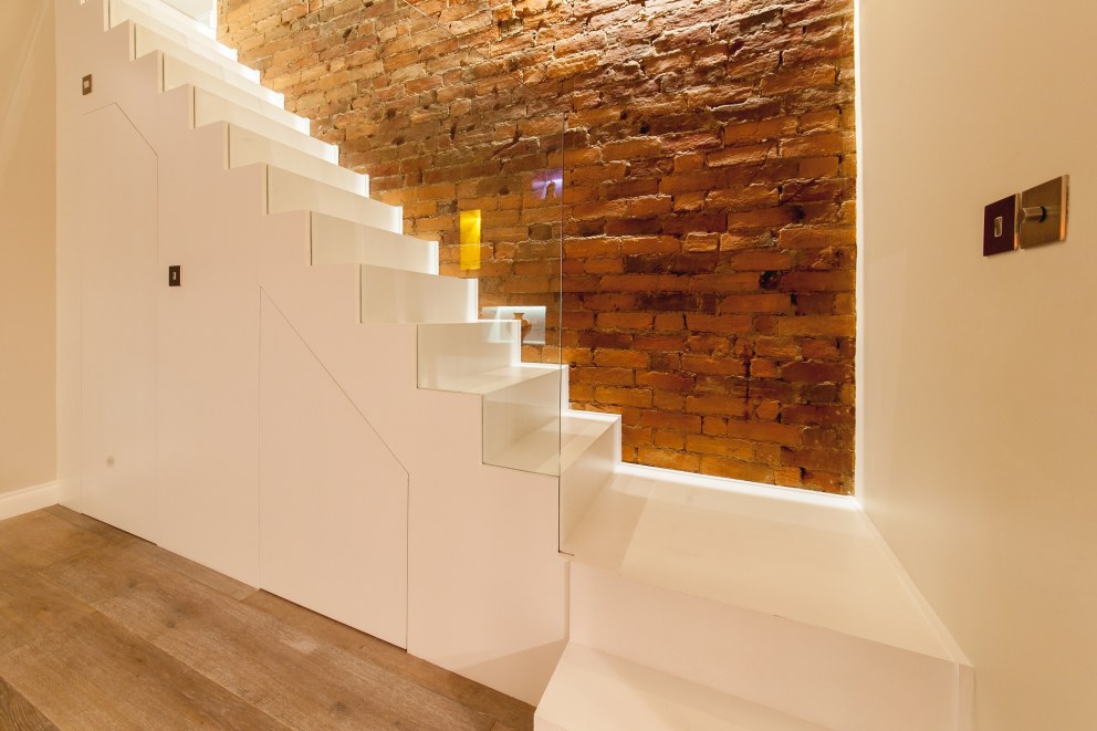 WEYBRIDGE HOUSE | White monolithic staircase | Interior Designers