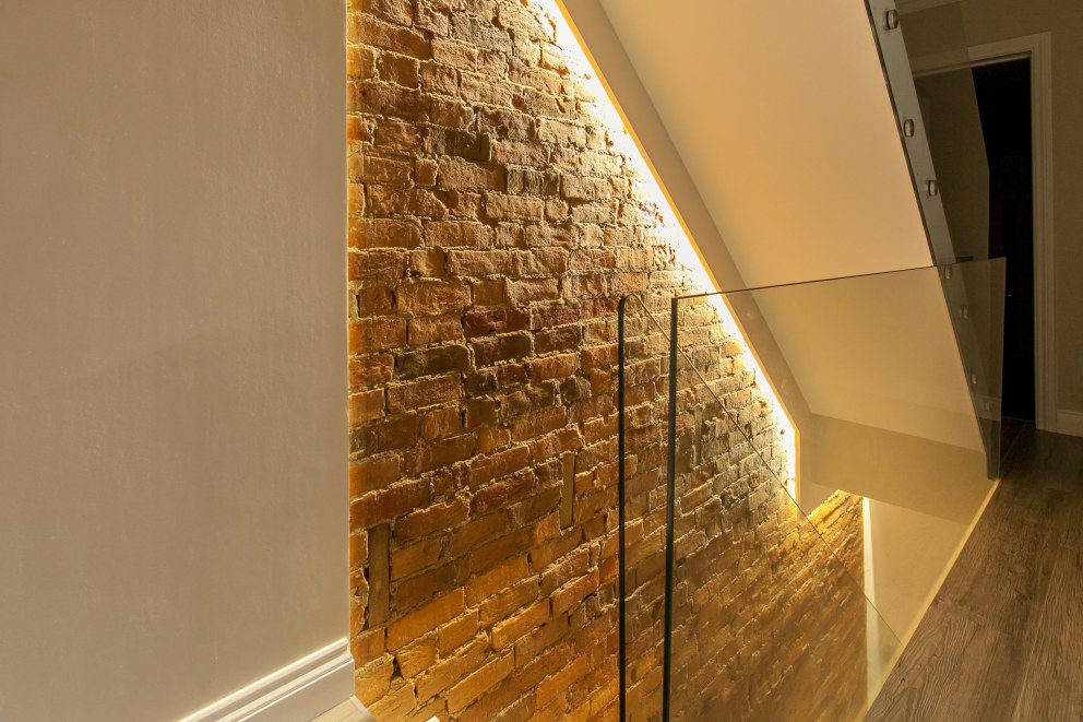 WEYBRIDGE HOUSE | Feature exposed brick wall | Interior Designers