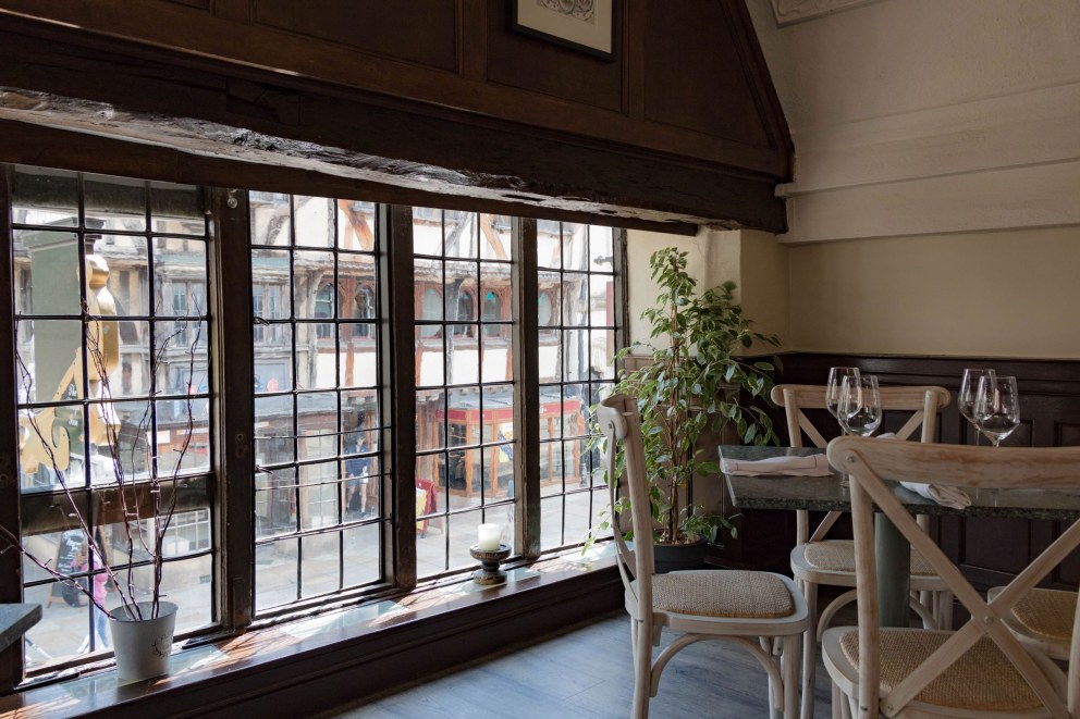 The Plough, Central Oxford | First floor corner table looking out over Cornmarket | Interior Designers