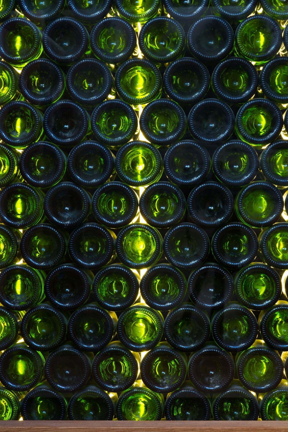 The Oxford Wine Cafe | Detail showing recycled glass wine bottle wall behind staircase to basement | Interior Designers