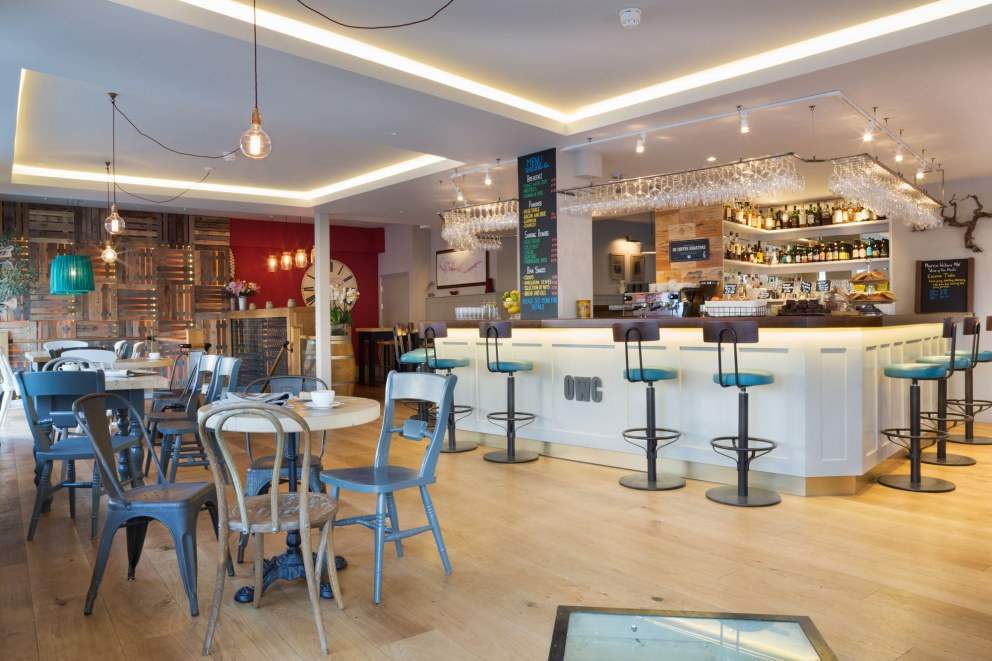 The Oxford Wine Cafe | Main entrance, showing bespoke bar and re-upholstered stools | Interior Designers