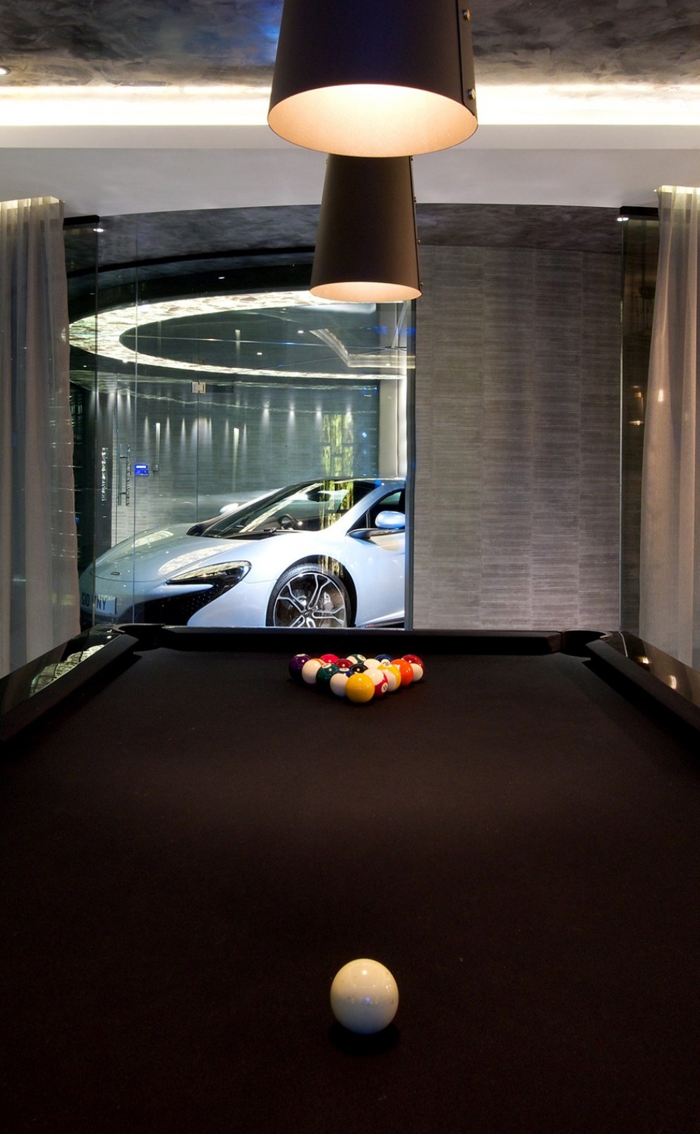 Ultimate mancave from awkward garage | view of the turntable down a cue | Interior Designers