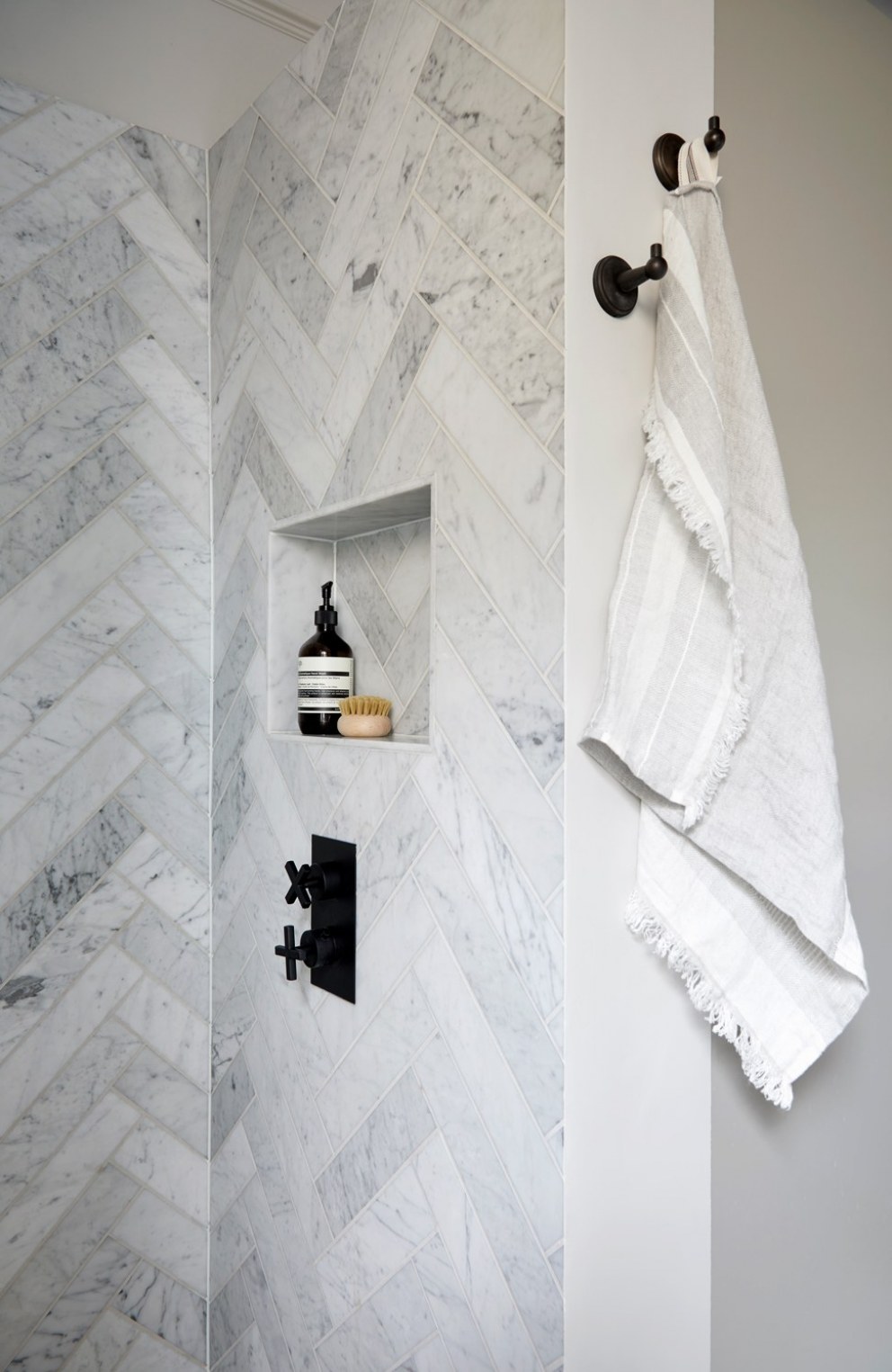 Ramsden Road | Monochrome master bathroom herringbone tiles | Interior Designers