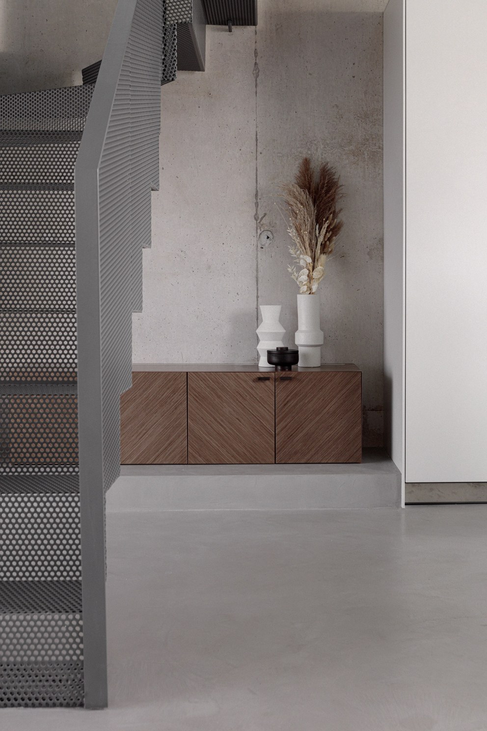 Wimbledon - New build home | Perforated metal staircase, bespoke joinery and exposed concrete wall | Interior Designers