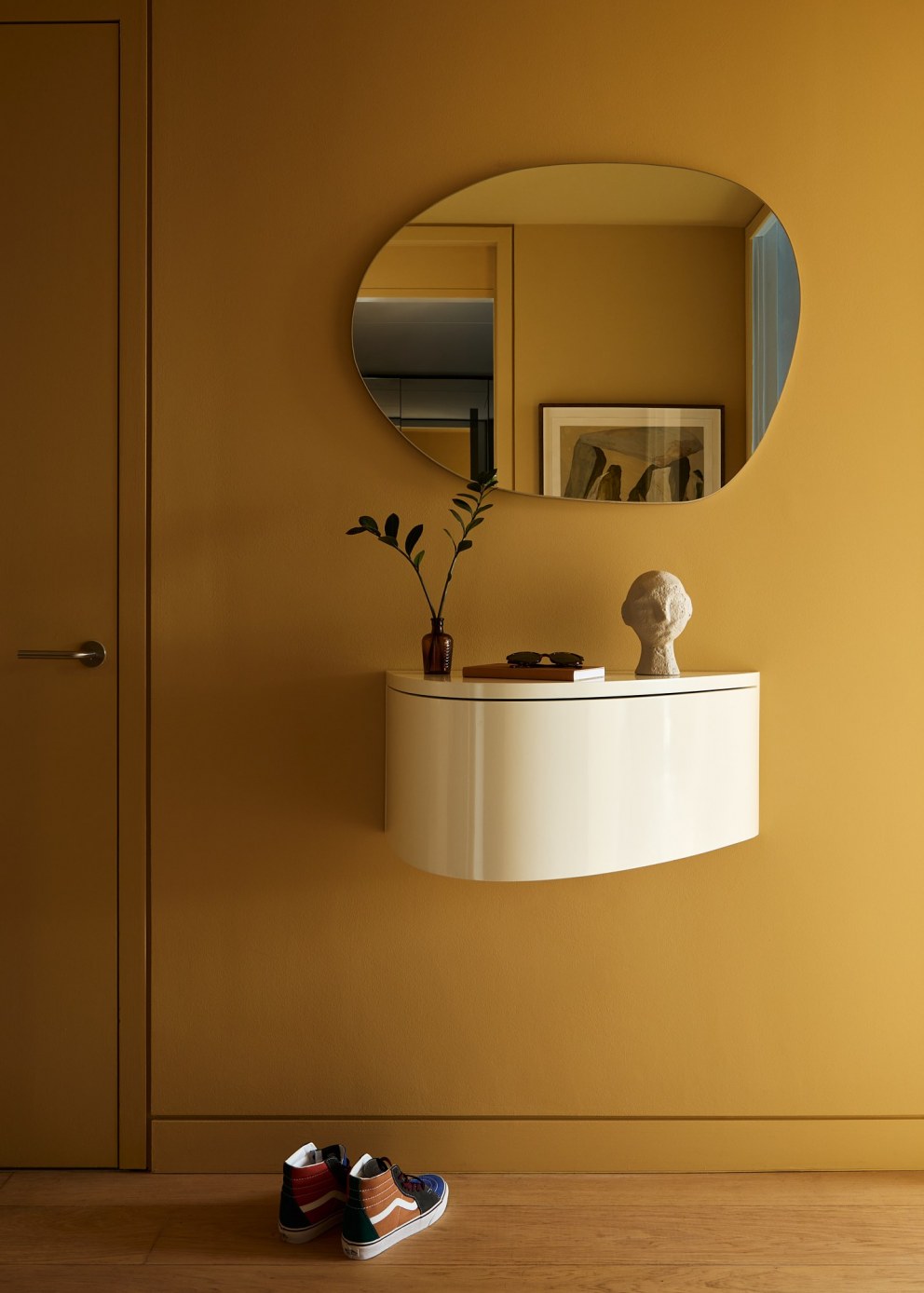 Bankside Apartment | Mustard coloured hallway to create an impact, with bespoke console table | Interior Designers