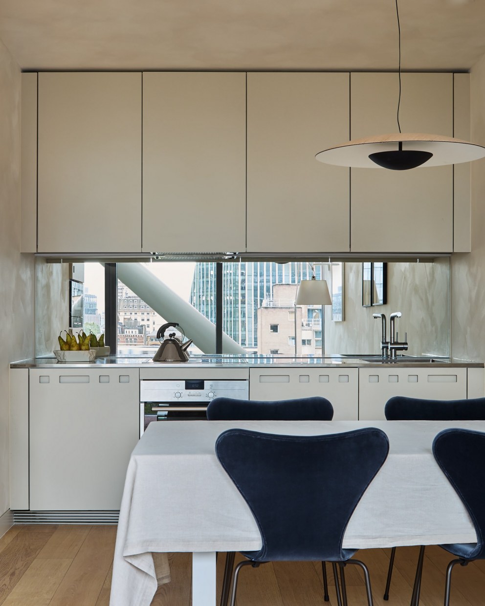 Bankside Apartment | Contemporary kitchen with steel & mirror | Interior Designers