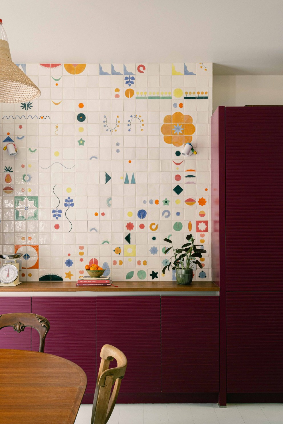 Bespoke ceramic wall tiles and colourful reclaimed kitchen cabinets ...