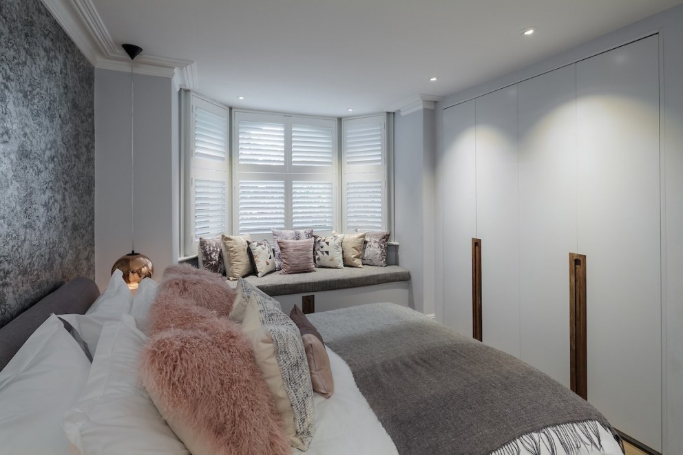 Belsize Park Basement Apartment | Basement Master Bedroom - Bespoke Joinery & windowseat | Interior Designers